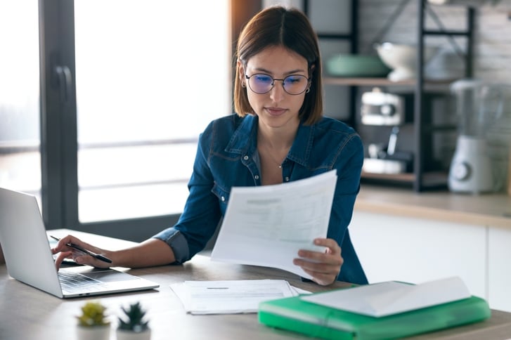 woman at desk working on laptop